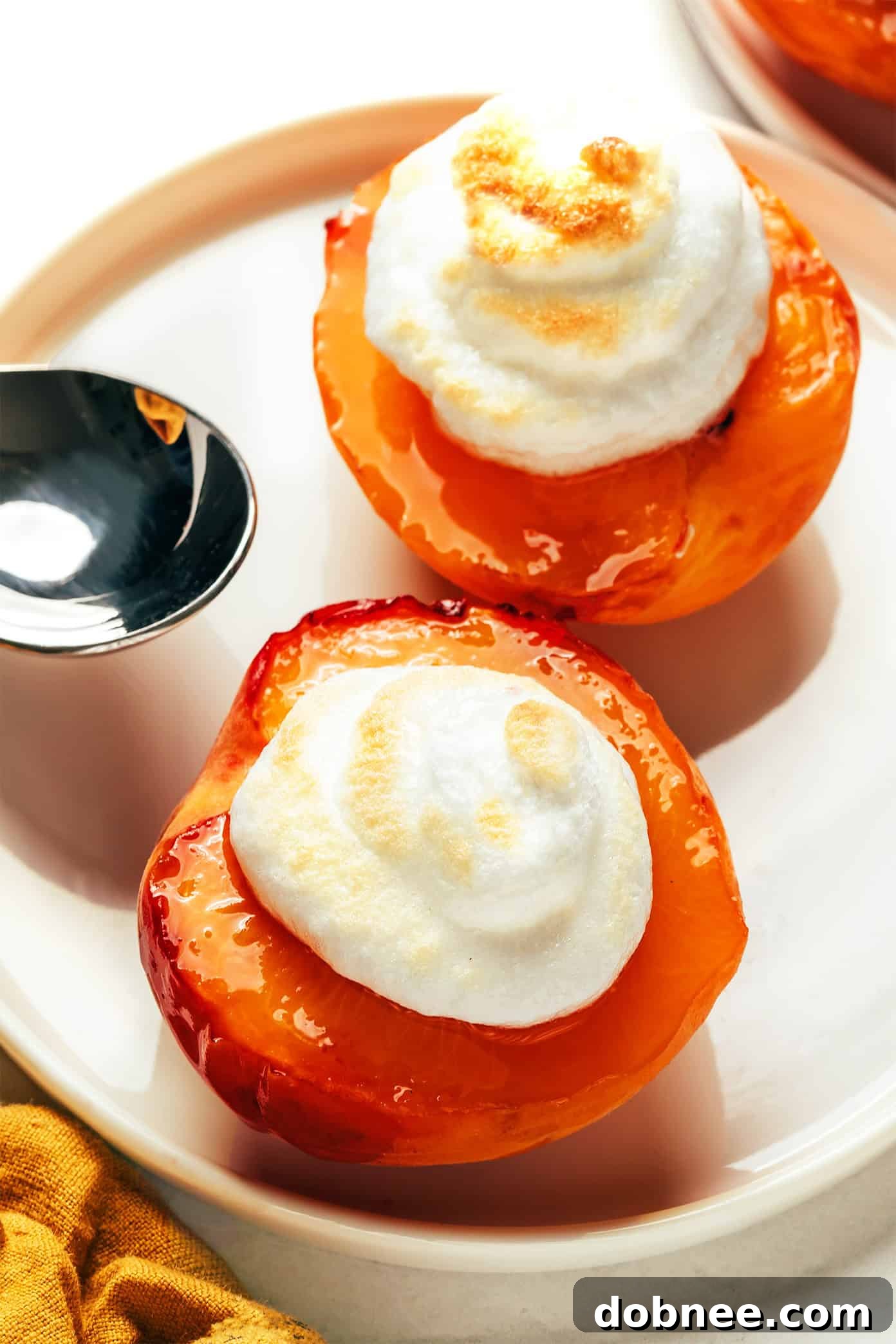 Fresh Peaches and Meringue dessert on a white plate with a fork.