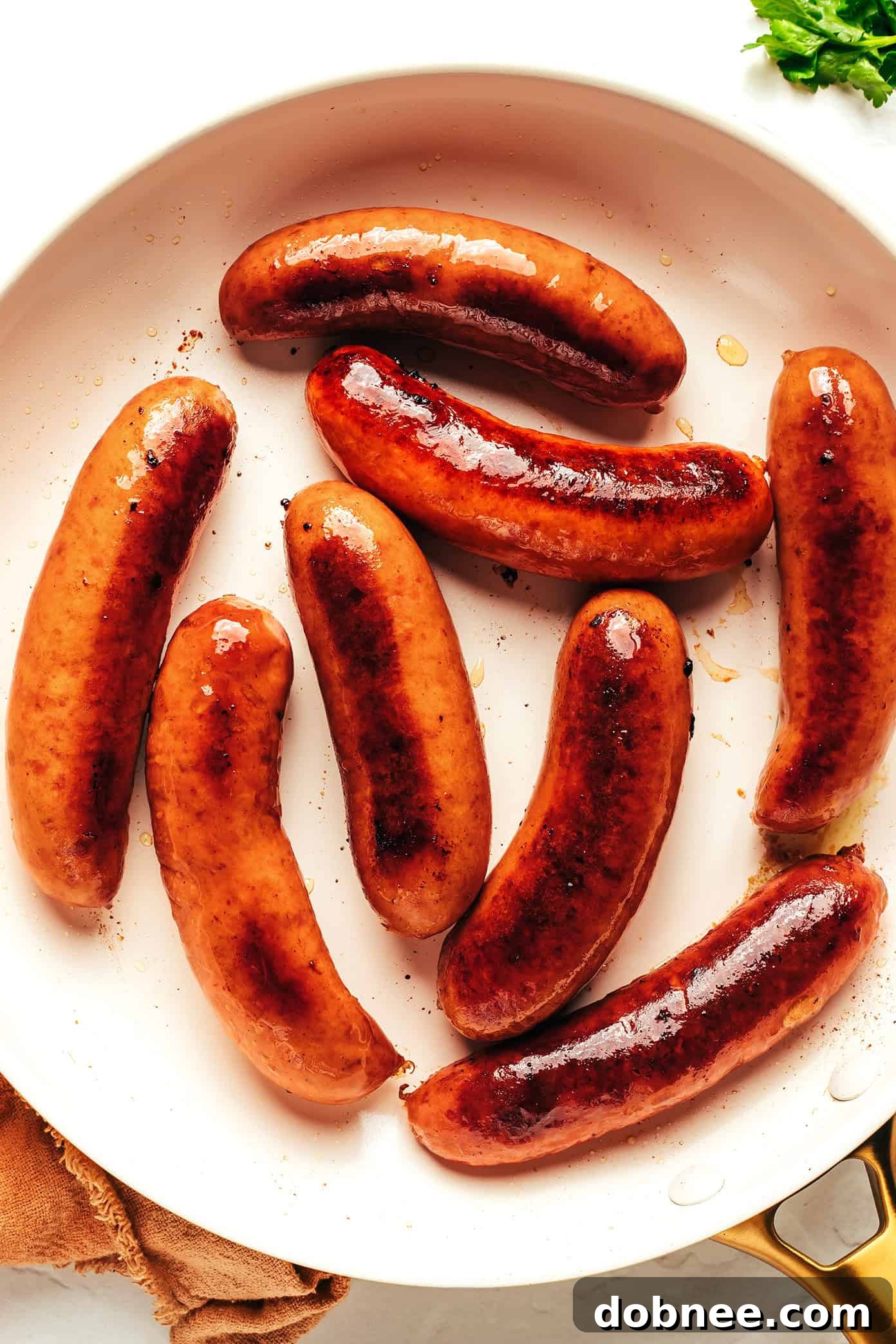 British Comfort Classic 3 A close-up view of a perfectly cooked banger with a spoonful of creamy mashed potatoes and glistening onion gravy.