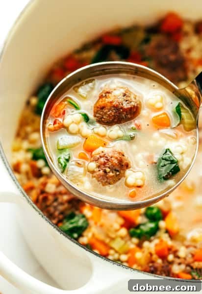 Italian Wedding Soup in a bowl with a spoon