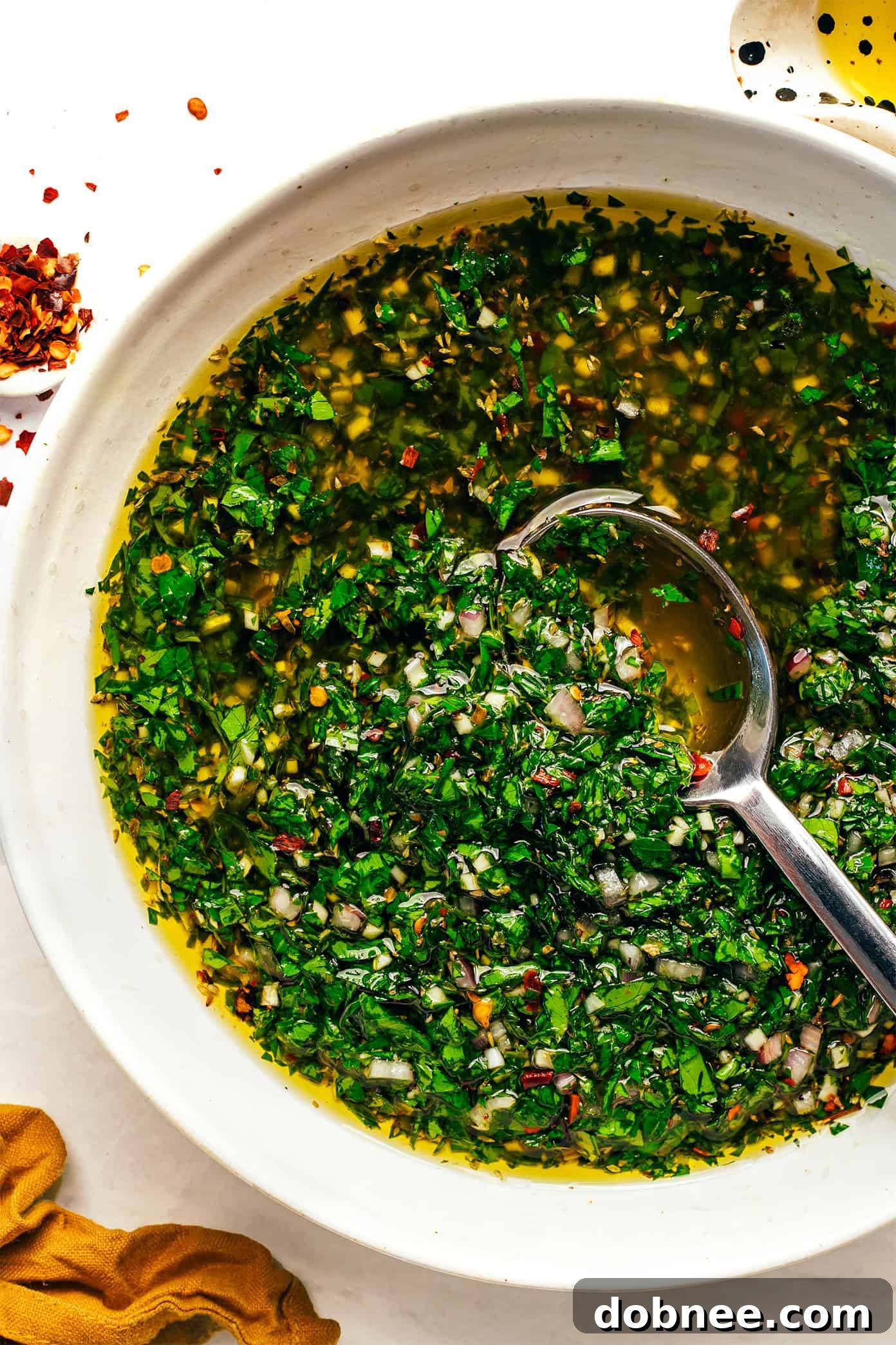 Freshly made chimichurri sauce in a bowl, ready to serve.