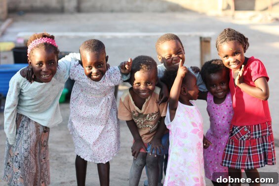 Sweet Children Smiling Two sweet children smiling brightly, with a warm, inviting backdrop, symbolizing hope and joy at a Zambian orphanage.