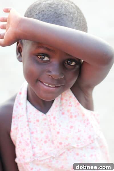Aggie at the Orphanage A young Zambian boy, Aggie, with a contemplative expression, showcasing the resilience of children at the orphanage.