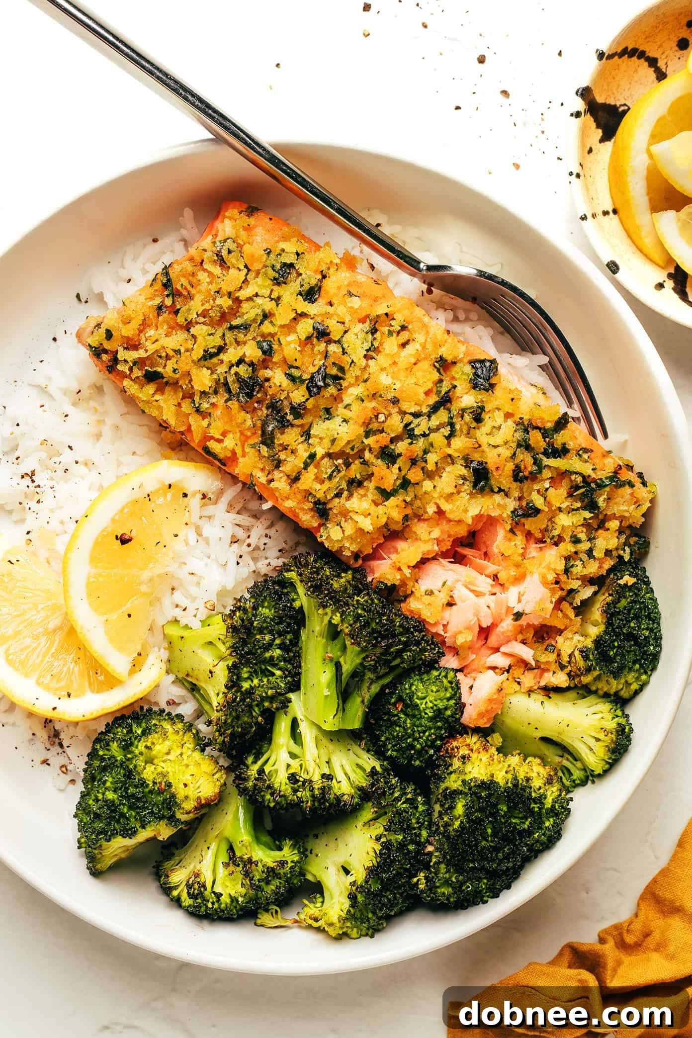Crispy honey mustard salmon with roasted broccoli on a baking sheet, fresh out of the oven.