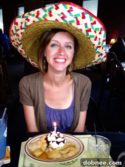 Smiling person wearing a festive sombrero, ready to enjoy a margarita.