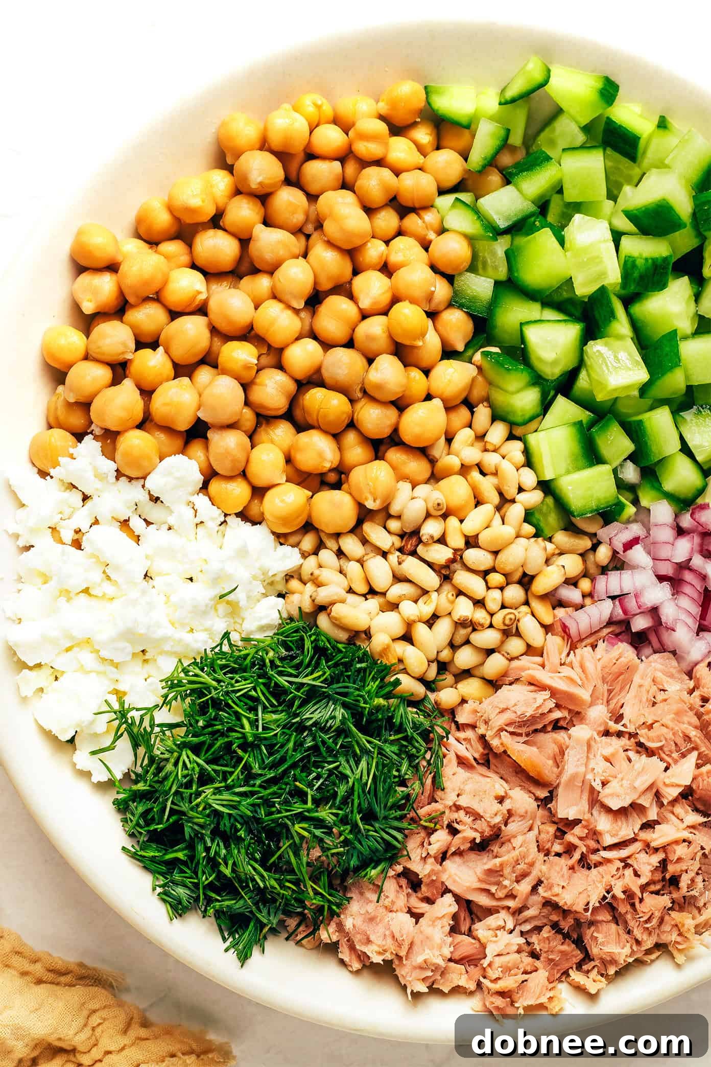 A close-up shot of the vibrant chickpea tuna salad, showing the mixed ingredients and creamy dressing.