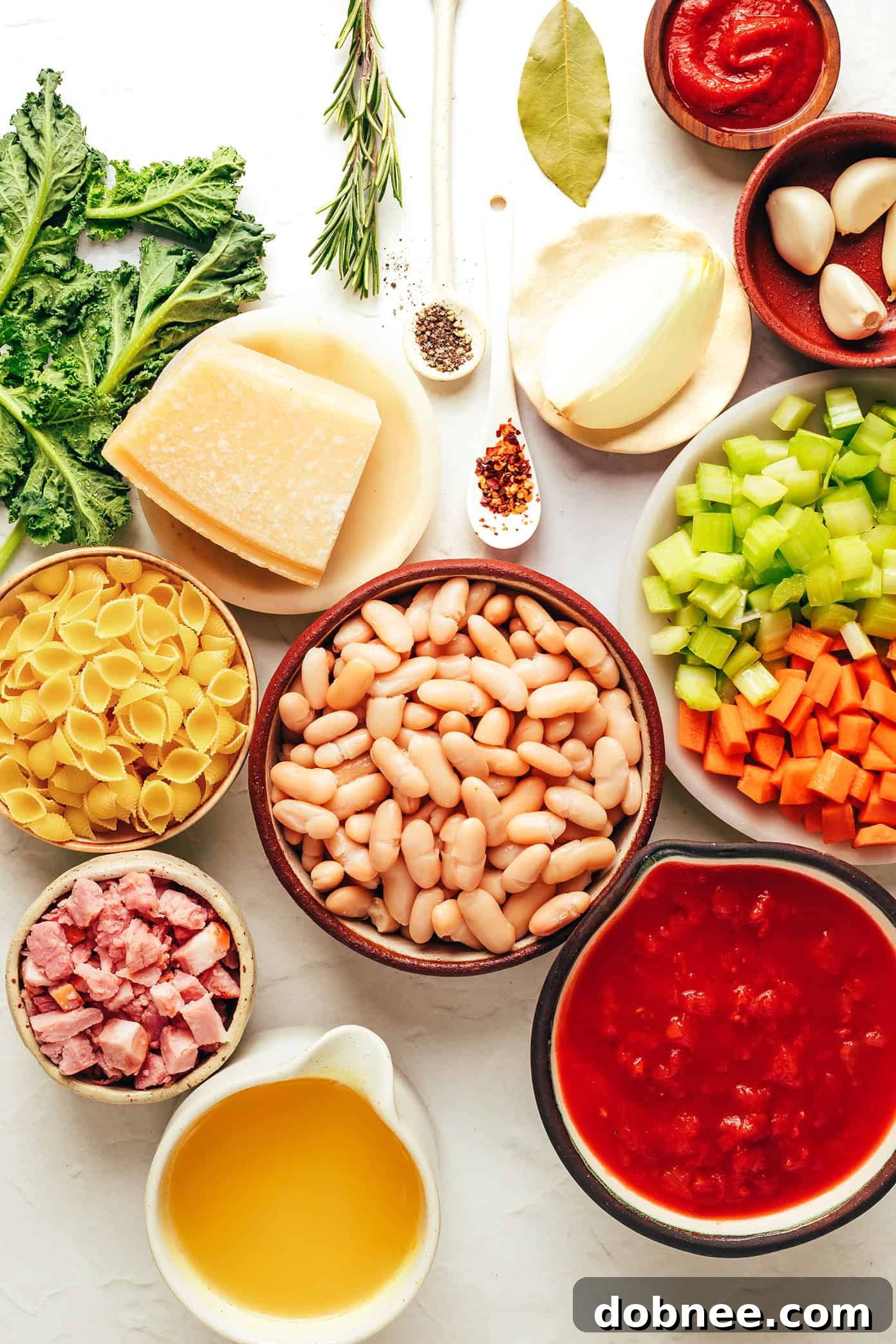 Close-up shot of Pasta e Fagioli in a bowl, showcasing the rich tomato broth, pasta, beans, and vegetables.
