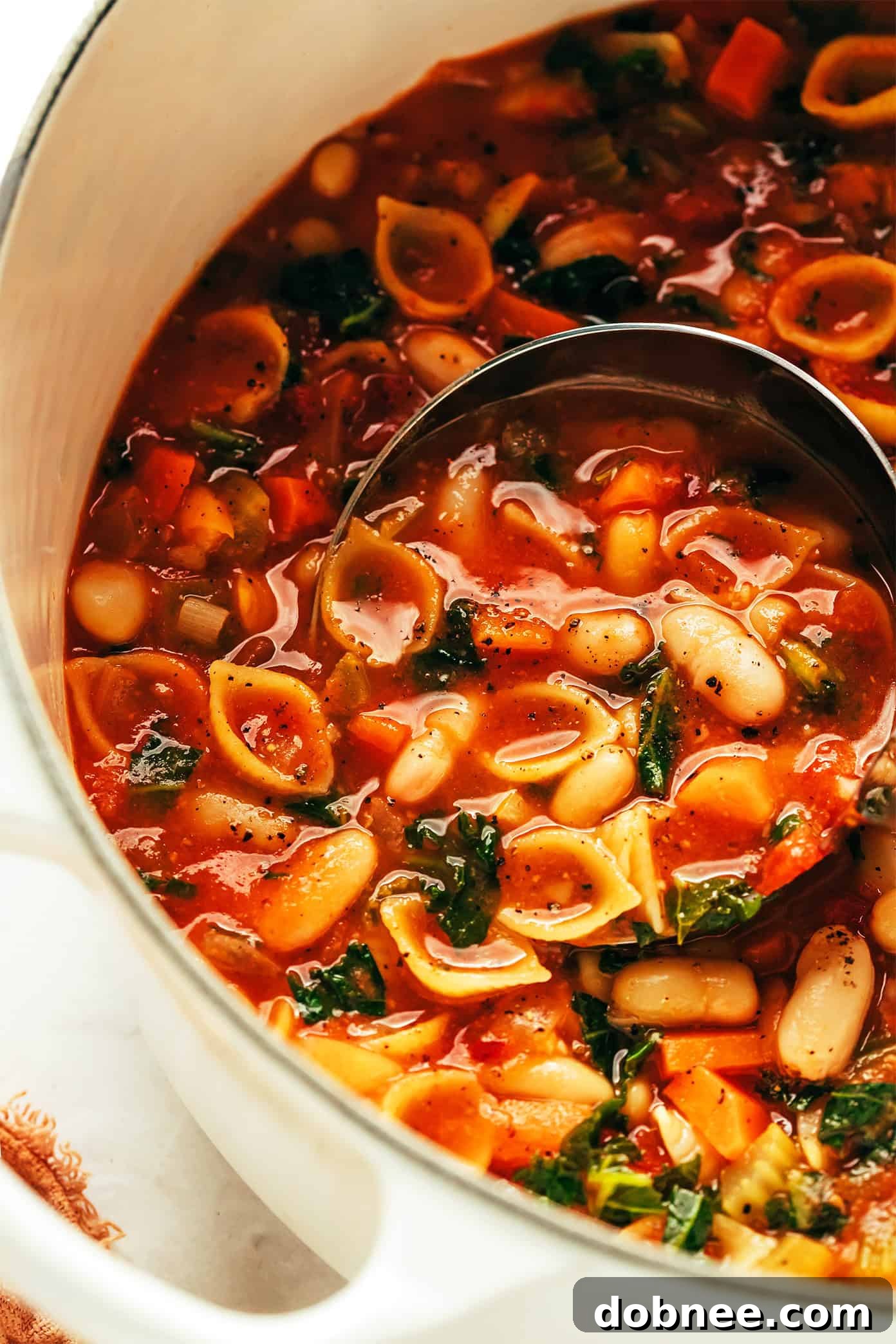 A large pot of Pasta e Fagioli simmering on the stove, ready to be served.