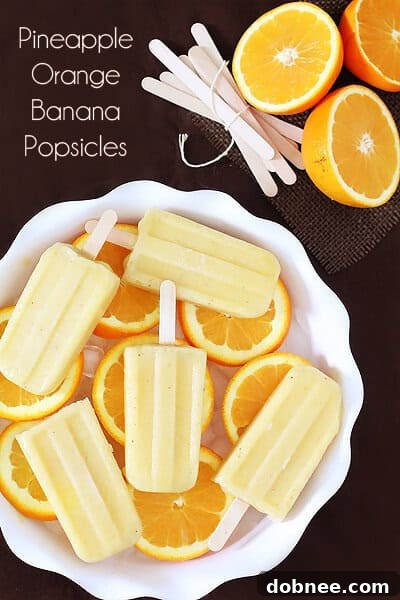 Close-up of three Pineapple Orange Banana Popsicles
