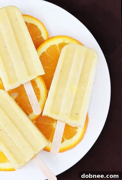 Pineapple Orange Banana Popsicles on a tray