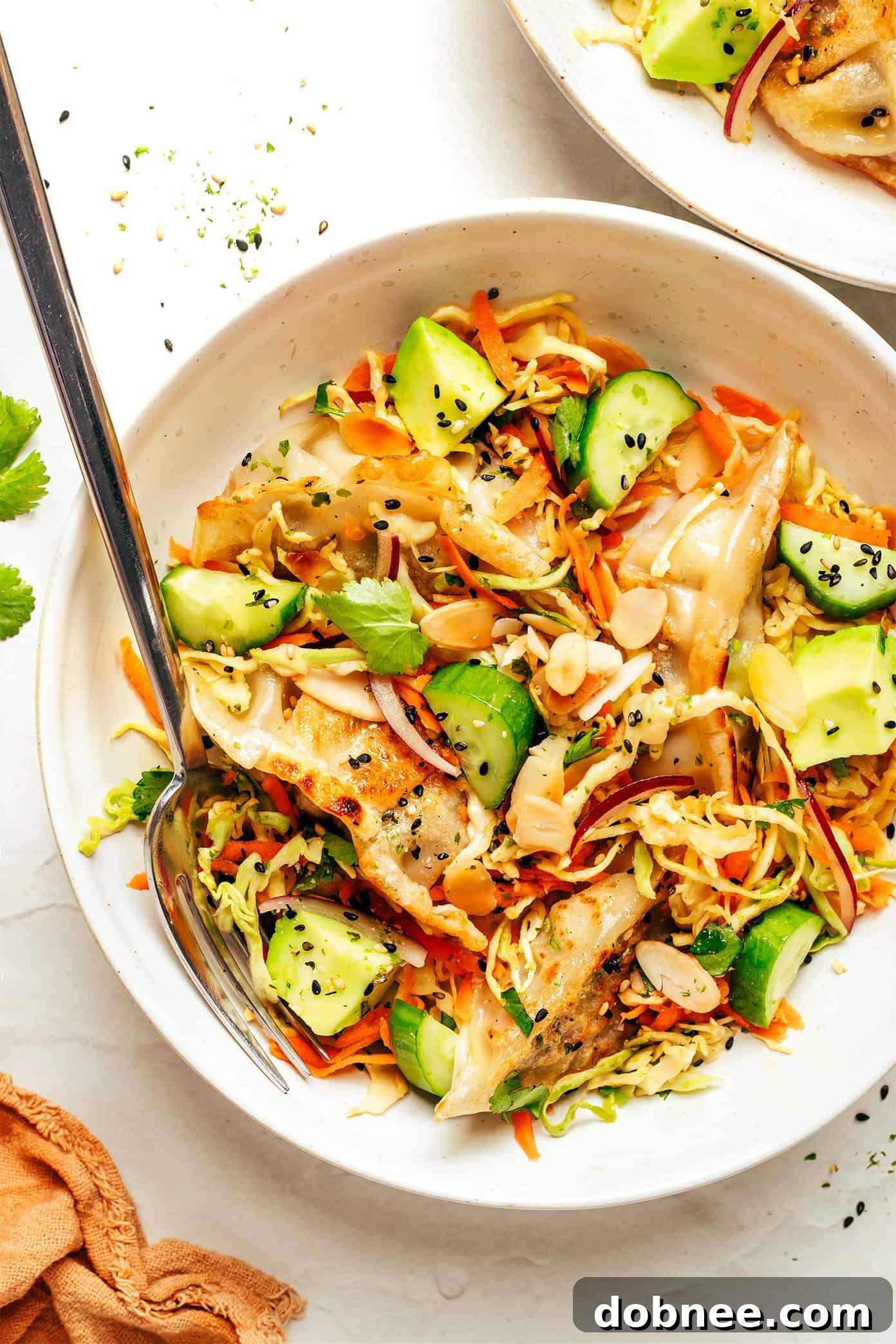 Potsticker Salad presented in a large bowl, showcasing crispy gyoza, fresh vegetables, and a vibrant dressing.