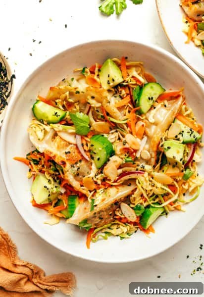 A bowl of Potsticker Salad with a serving spoon, ready to be enjoyed.