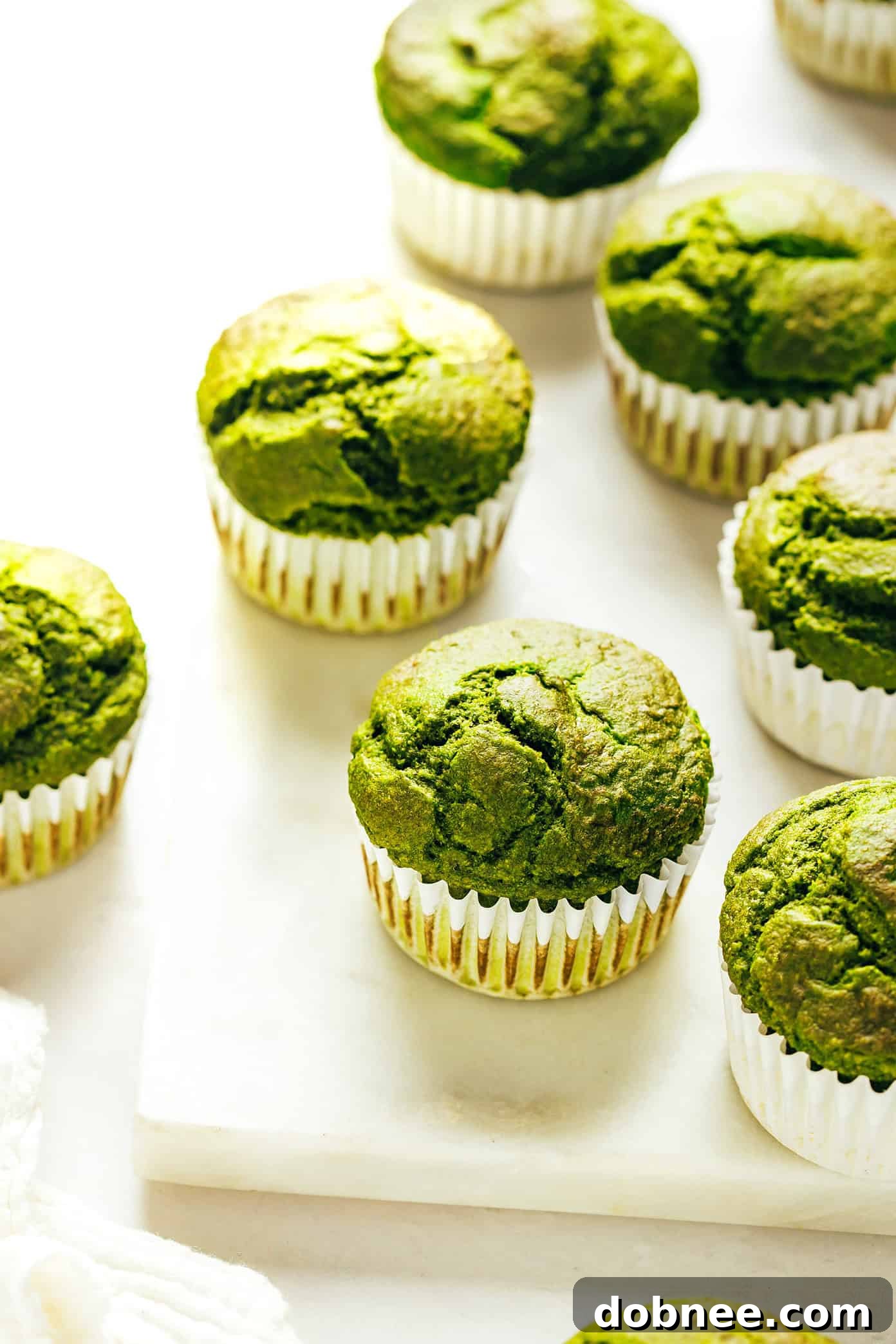 Kid-Approved Blender Spinach Banana Muffins: Healthy, Delicious, and Gluten-Free! Green blender spinach banana muffins stacked on a plate
