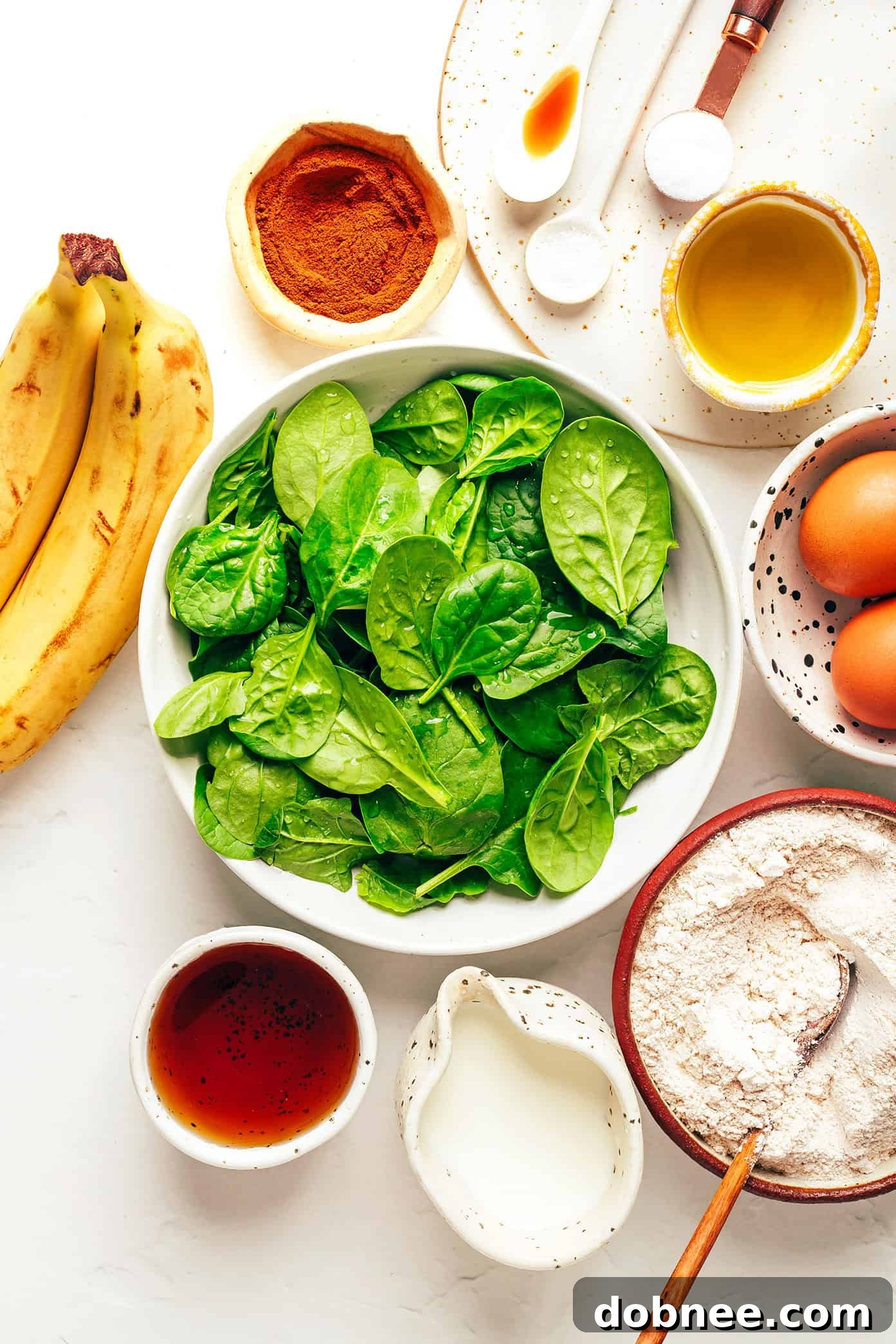 Simple Ingredients for Healthy Blender Spinach Banana Muffins green muffin ingredients laid out on a table