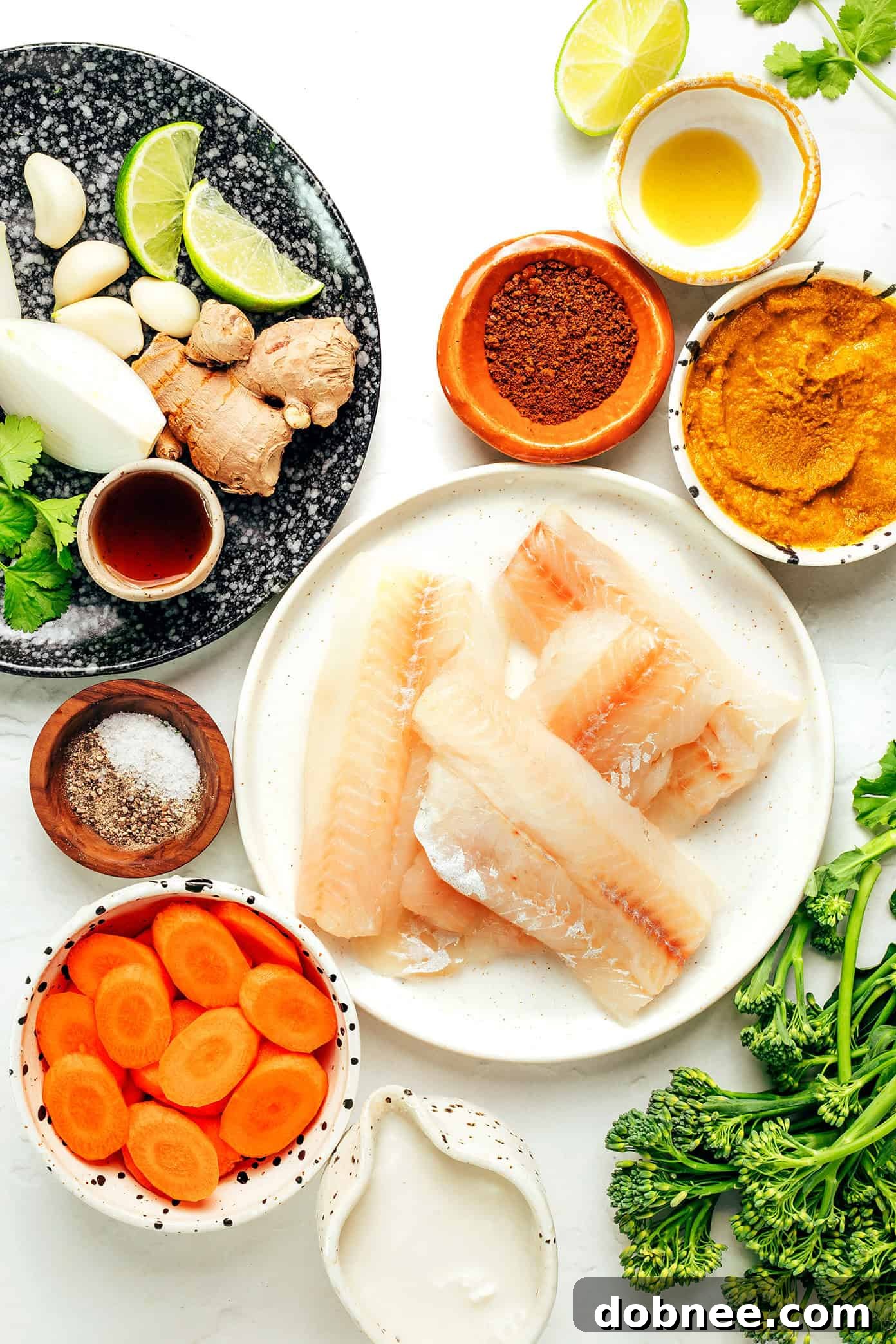 Ingredients for Thai Fish Curry laid out on a wooden board