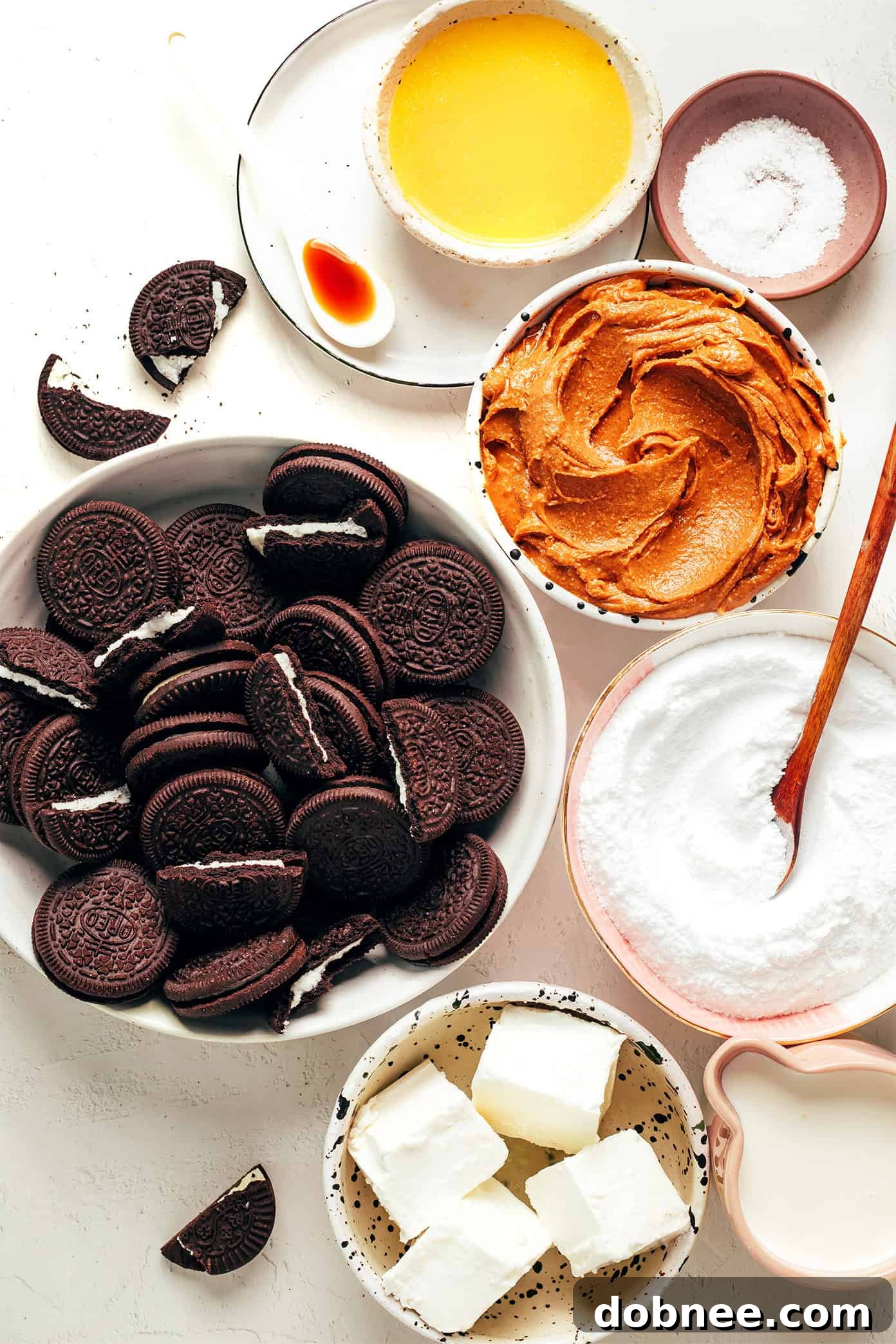 Ingredients laid out for making the ultimate no-bake peanut butter pie, including Oreo cookies, peanut butter, cream cheese, heavy cream, and powdered sugar.