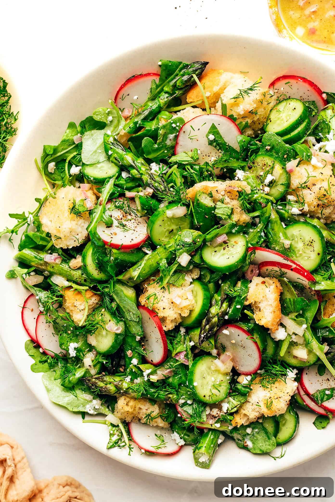 This vibrant spring panzanella salad recipe features crispy sourdough croutons, roasted asparagus, fresh veggies, herbs, feta, and a lemony shallot vinaigrette. | gimmesomeoven.com Spring Panzanella with Sourdough Croutons