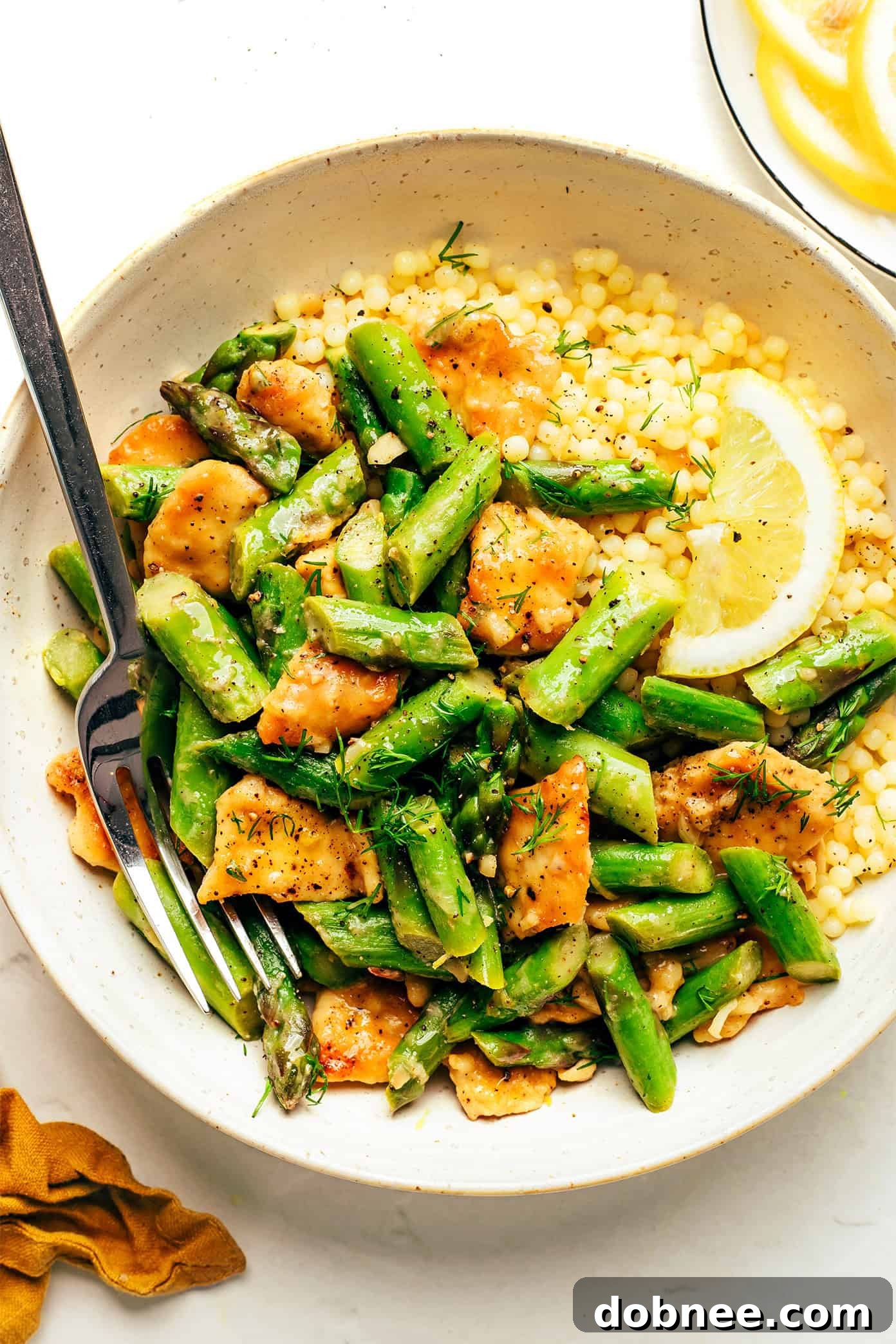 Overhead shot of Lemon Pepper Chicken and Asparagus Stir-fry in a serving bowl