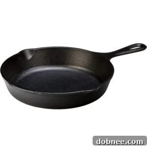 Arrangement of fresh ingredients including sliced steak, red and green bell peppers, yellow onion, mushrooms, and a block of provolone cheese.