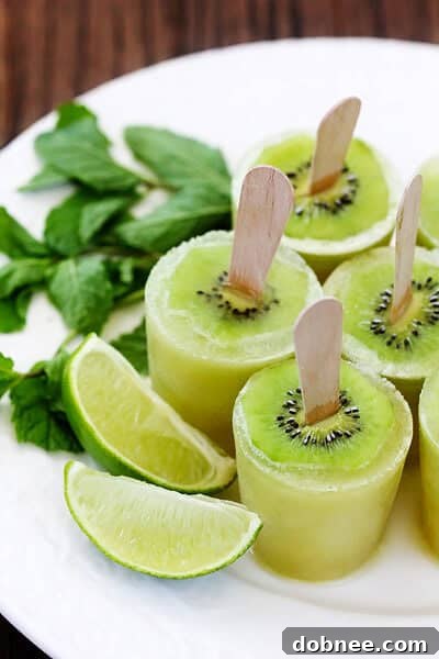 Close-up of a kiwi mojito popsicle showing a slice of kiwi garnish