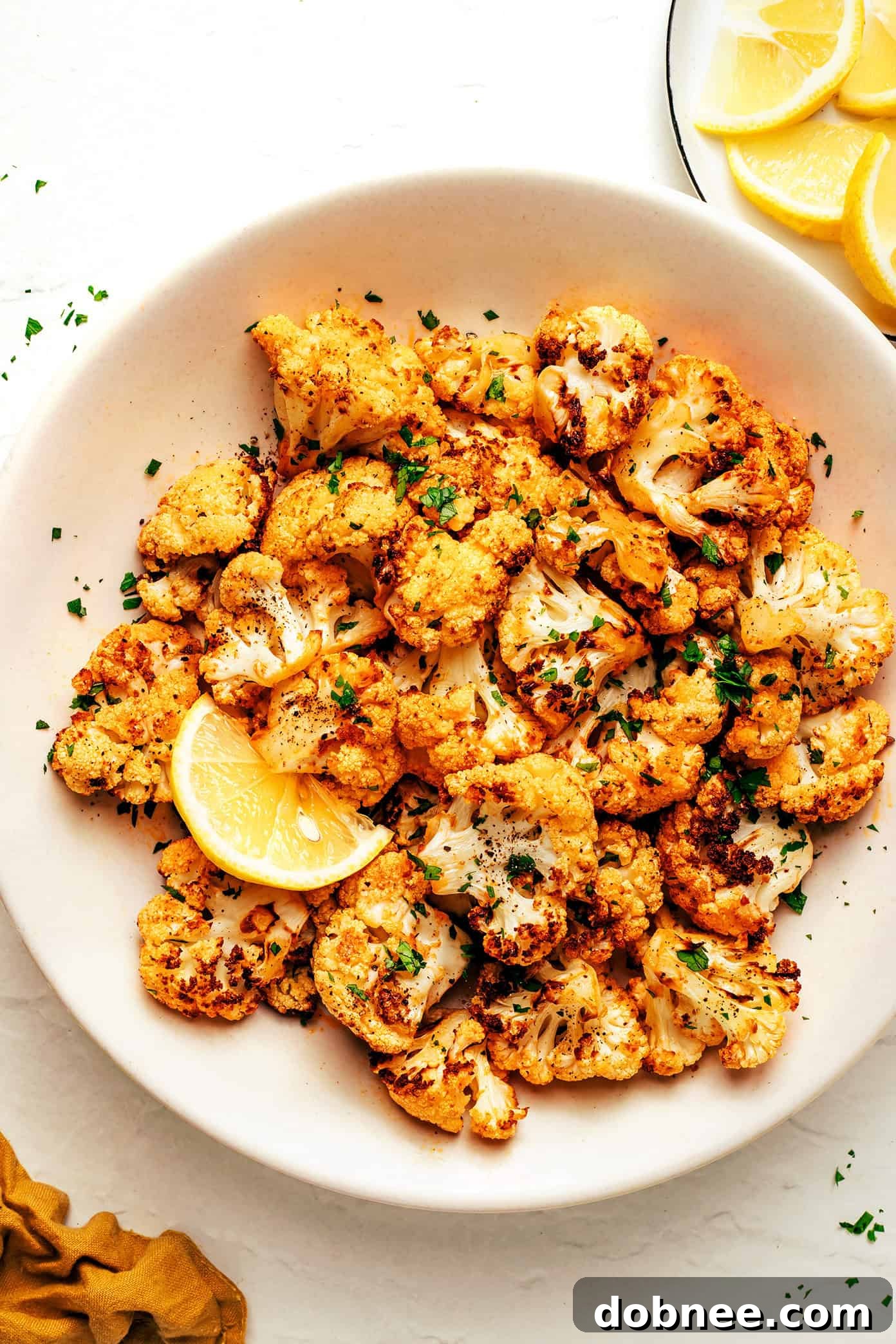 Air fryer cauliflower florets seasoned and ready for cooking.