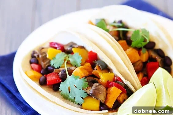 Delicious roasted vegetable and black bean tacos on corn tortillas