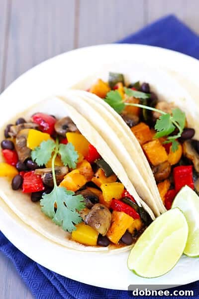 Close-up of roasted vegetable and black bean tacos with fresh cilantro