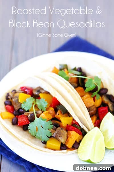 Arrangement of roasted vegetable and black bean tacos on a wooden board
