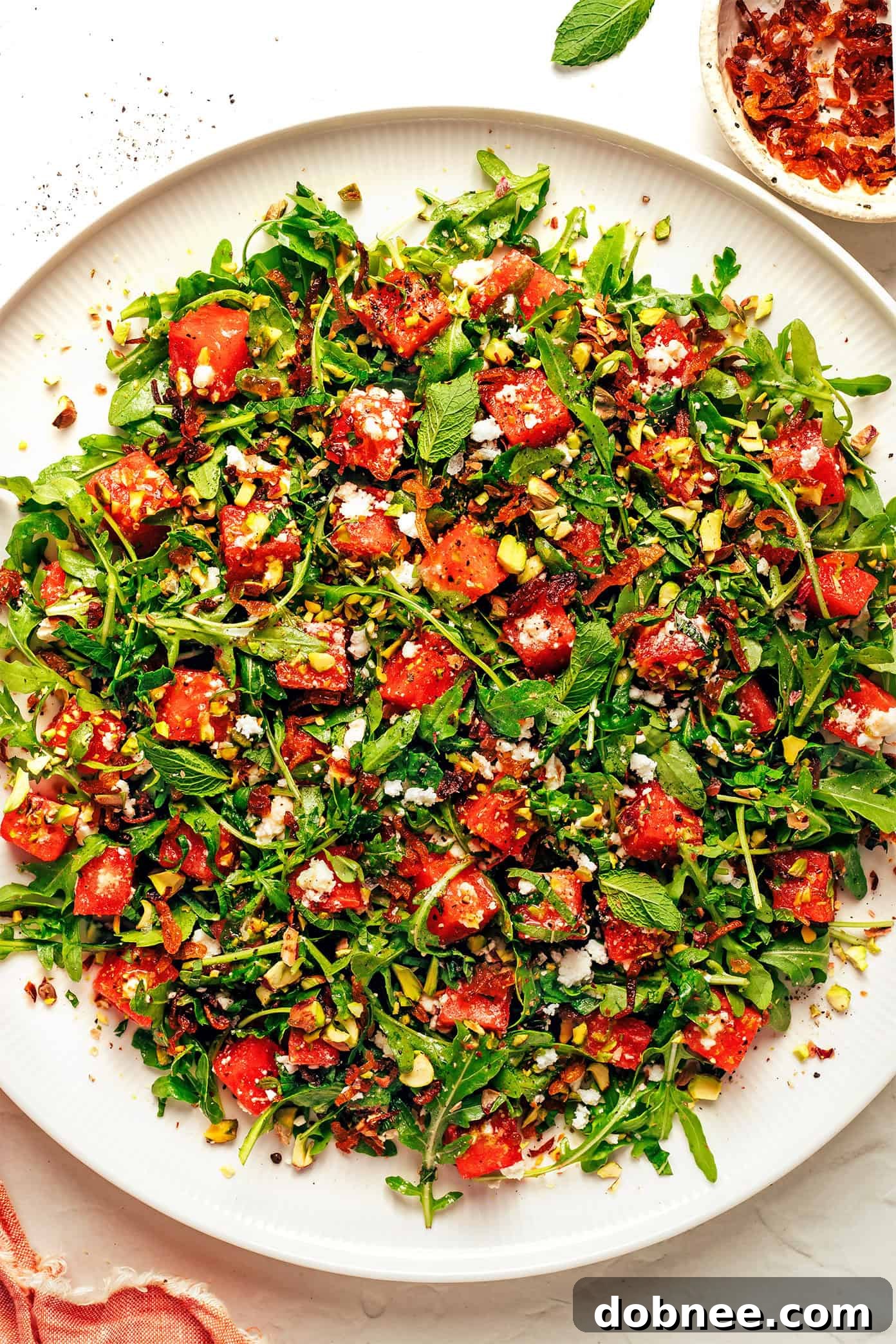 Close-up of watermelon arugula salad with dressing