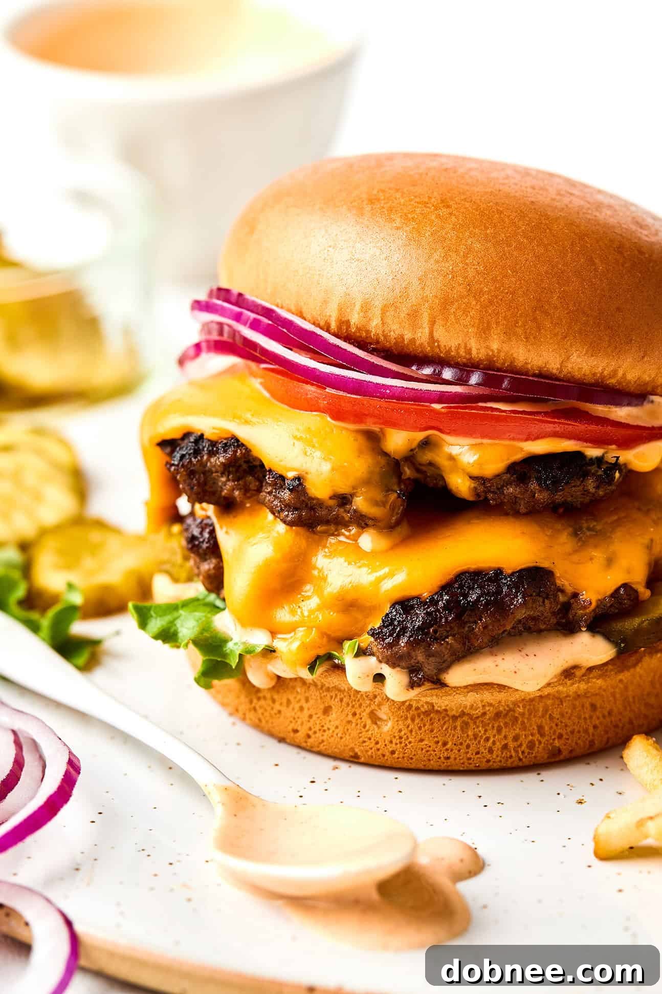 A delicious smash burger topped with burger sauce, lettuce, and pickles