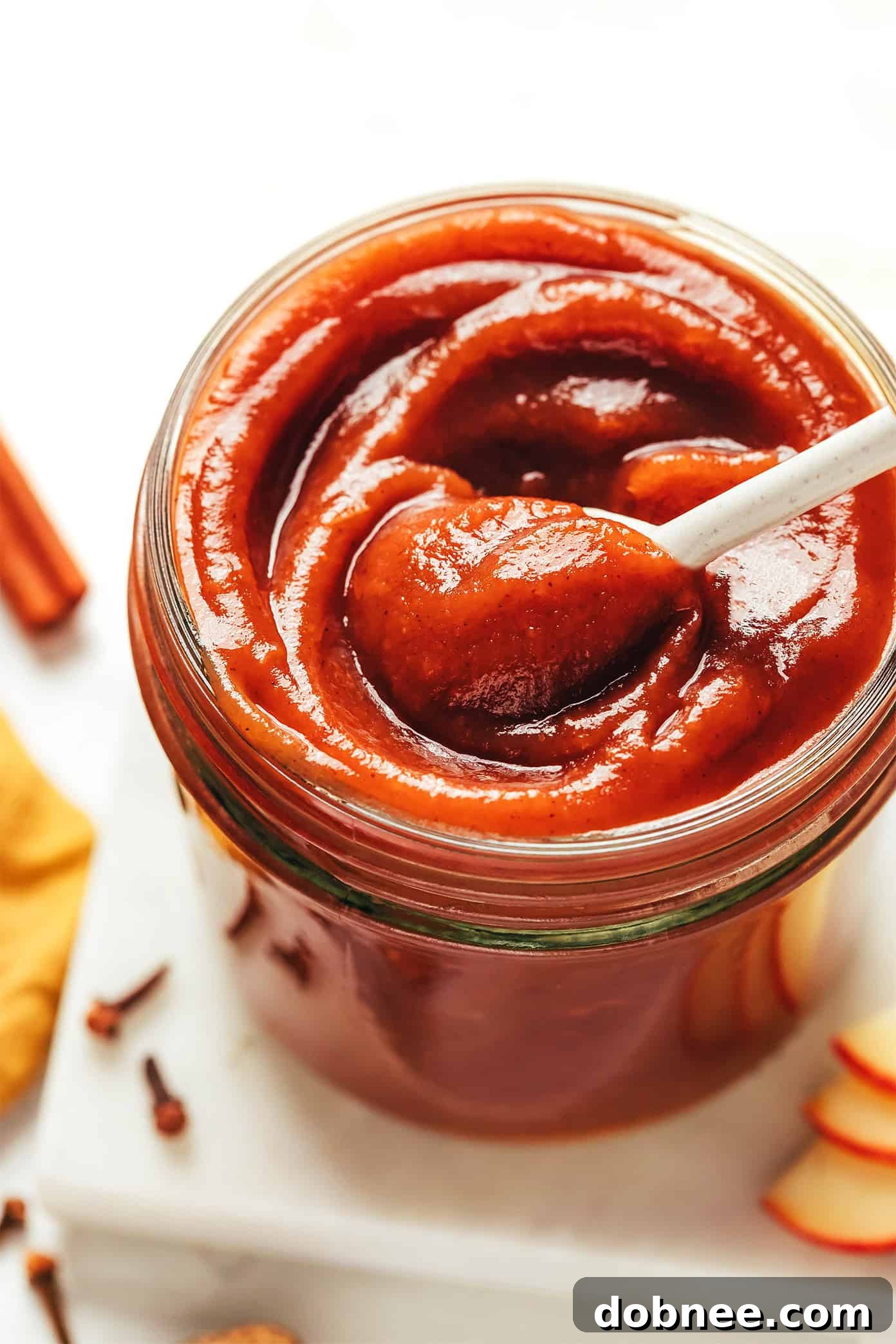 Fresh apples piled high in a rustic basket, ready for cooking.
