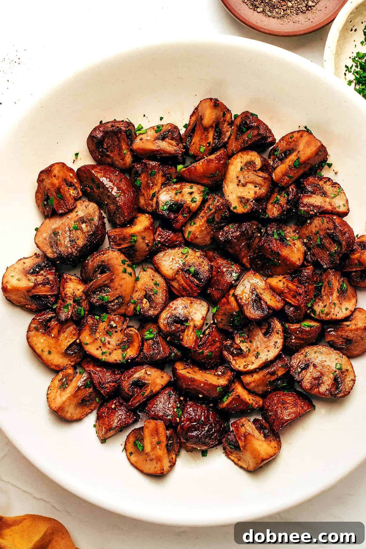 Golden brown, crispy air fryer mushrooms in a bowl.