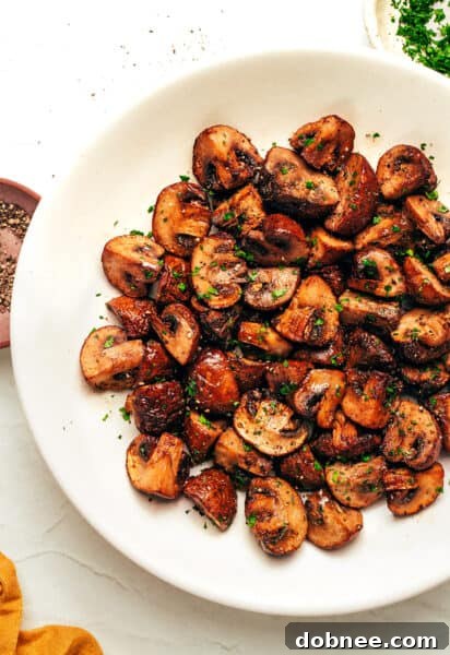 A close-up of beautifully seasoned and air-fried mushrooms.