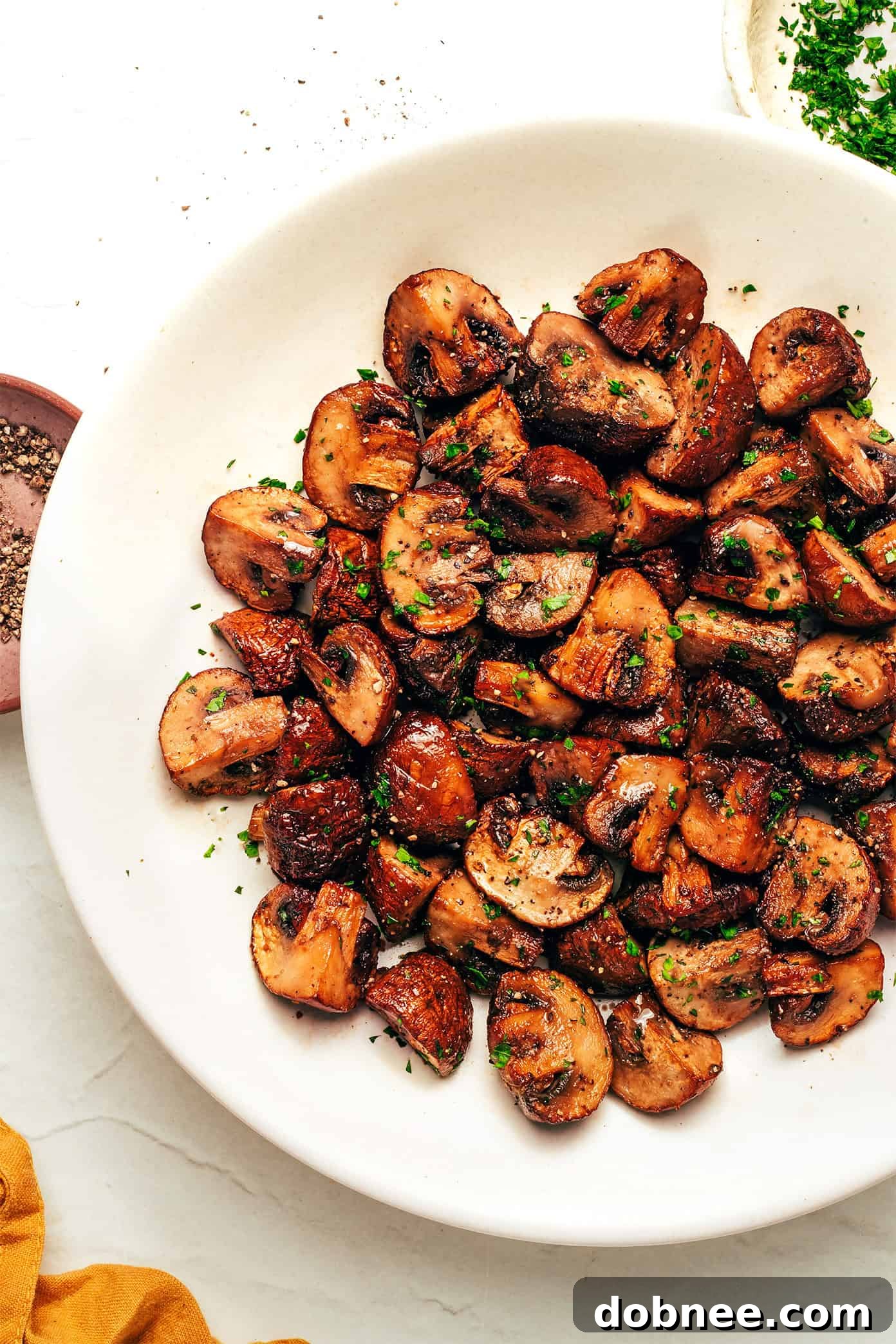 A serving of air fryer mushrooms with fresh parsley garnish.
