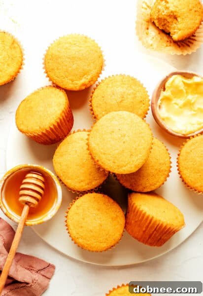 A batch of golden brown cornbread muffins, freshly baked and delicious.
