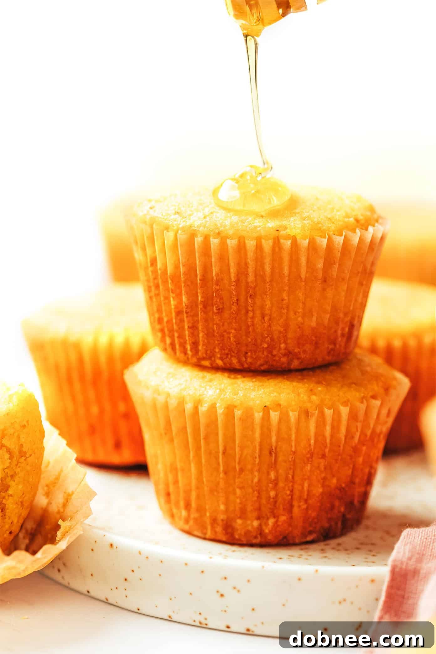 A close-up shot of golden brown cornbread muffins, ready to be enjoyed with a hot meal.