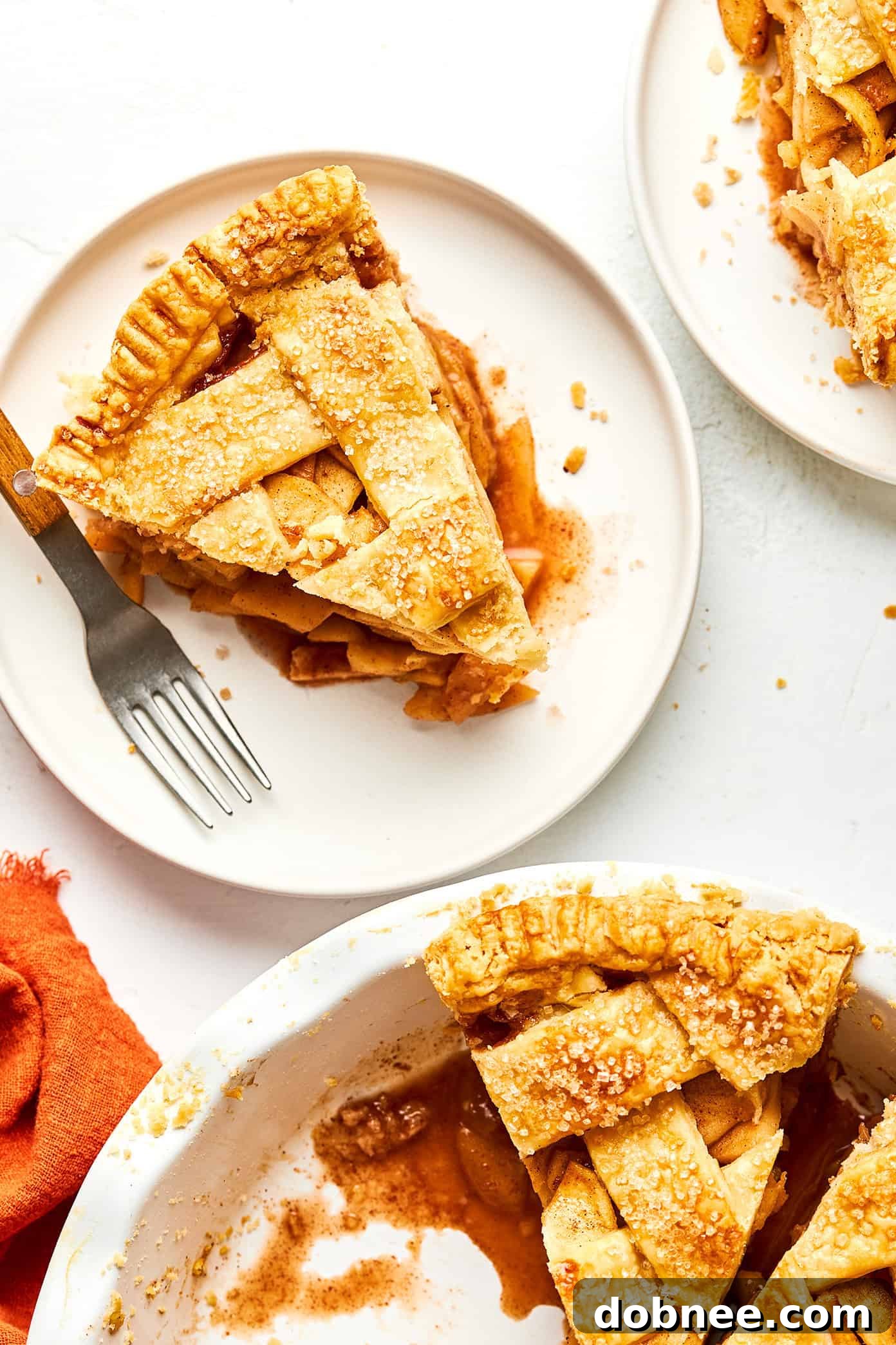 Multiple slices of homemade apple pie neatly arranged on a platter, showcasing the golden crust and tender apple filling.