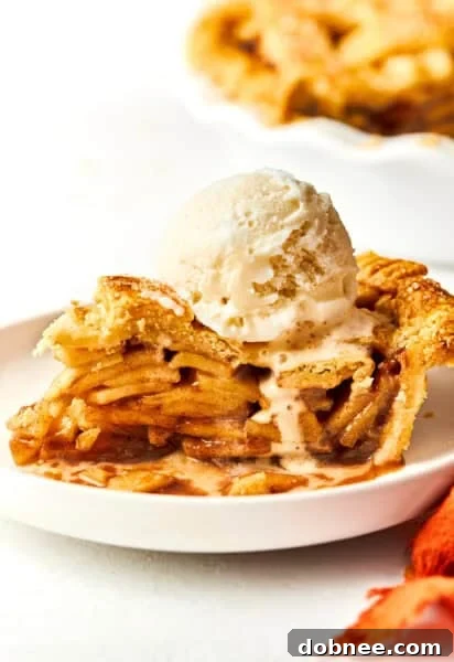 A vibrant close-up of a rustic apple pie, showcasing its golden-brown crust and juicy filling.