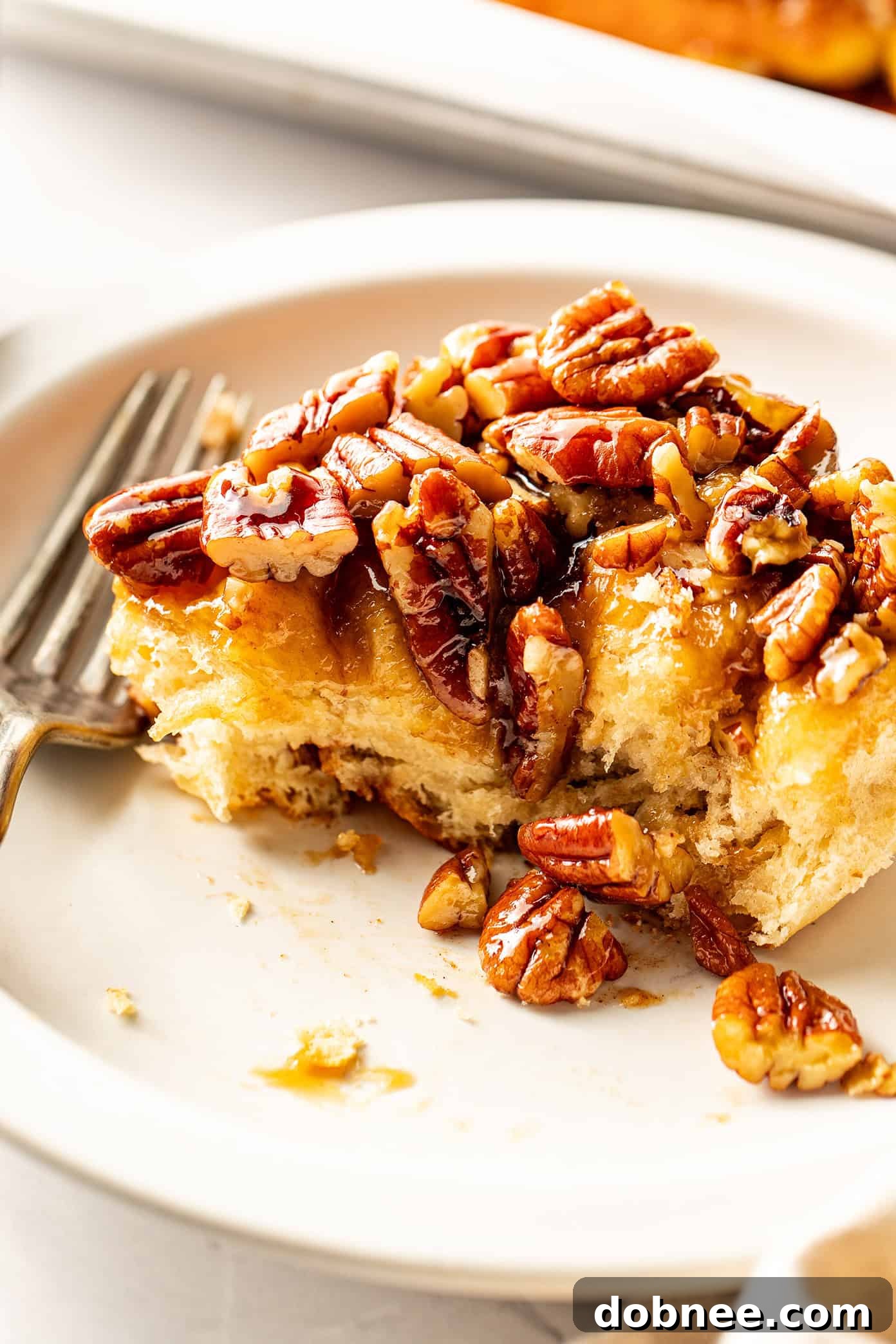 The finished sticky buns, glistening with caramel and pecans, beautifully arranged and pulled apart to reveal their soft, inviting interior