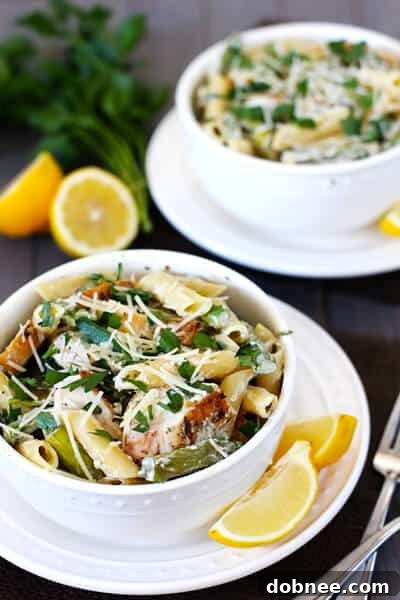 Close-up of Lemon Rosemary Pasta with Chicken, Asparagus, and Spinach in a serving bowl, highlighting the creamy texture and fresh ingredients.