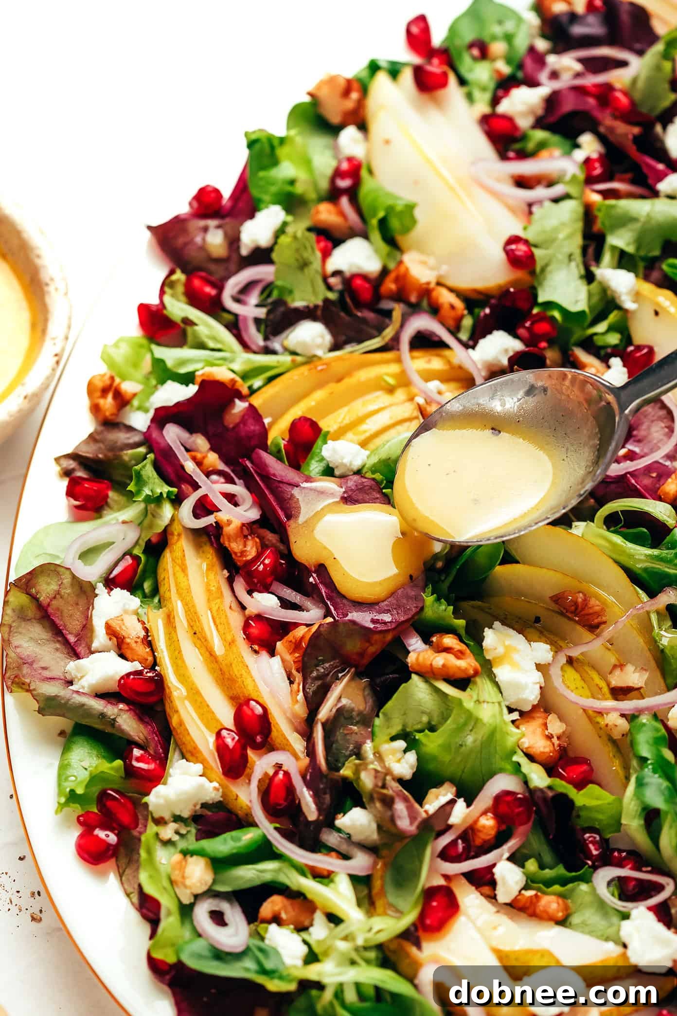 Golden Pear Salad 5 drizzling white balsamic vinaigrette on pear salad