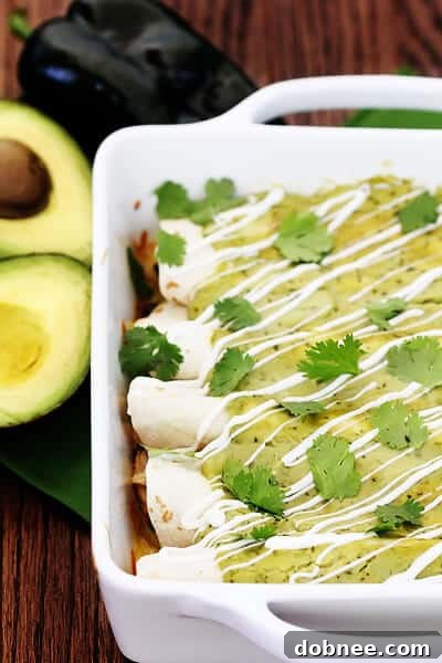 Another view of the baked Chicken & Avocado Enchiladas, showing the rich filling and creamy topping.