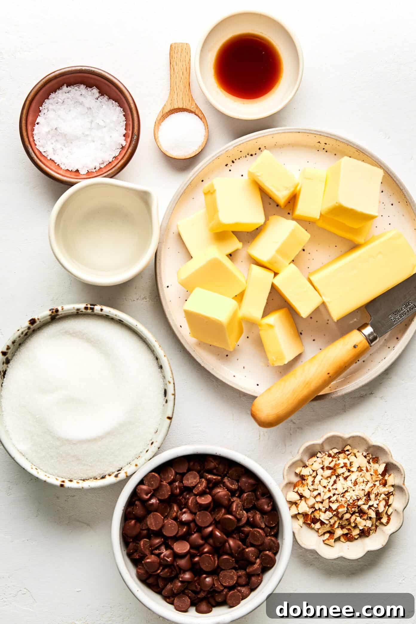 A close-up shot of golden-brown toffee pieces with chocolate and nuts.