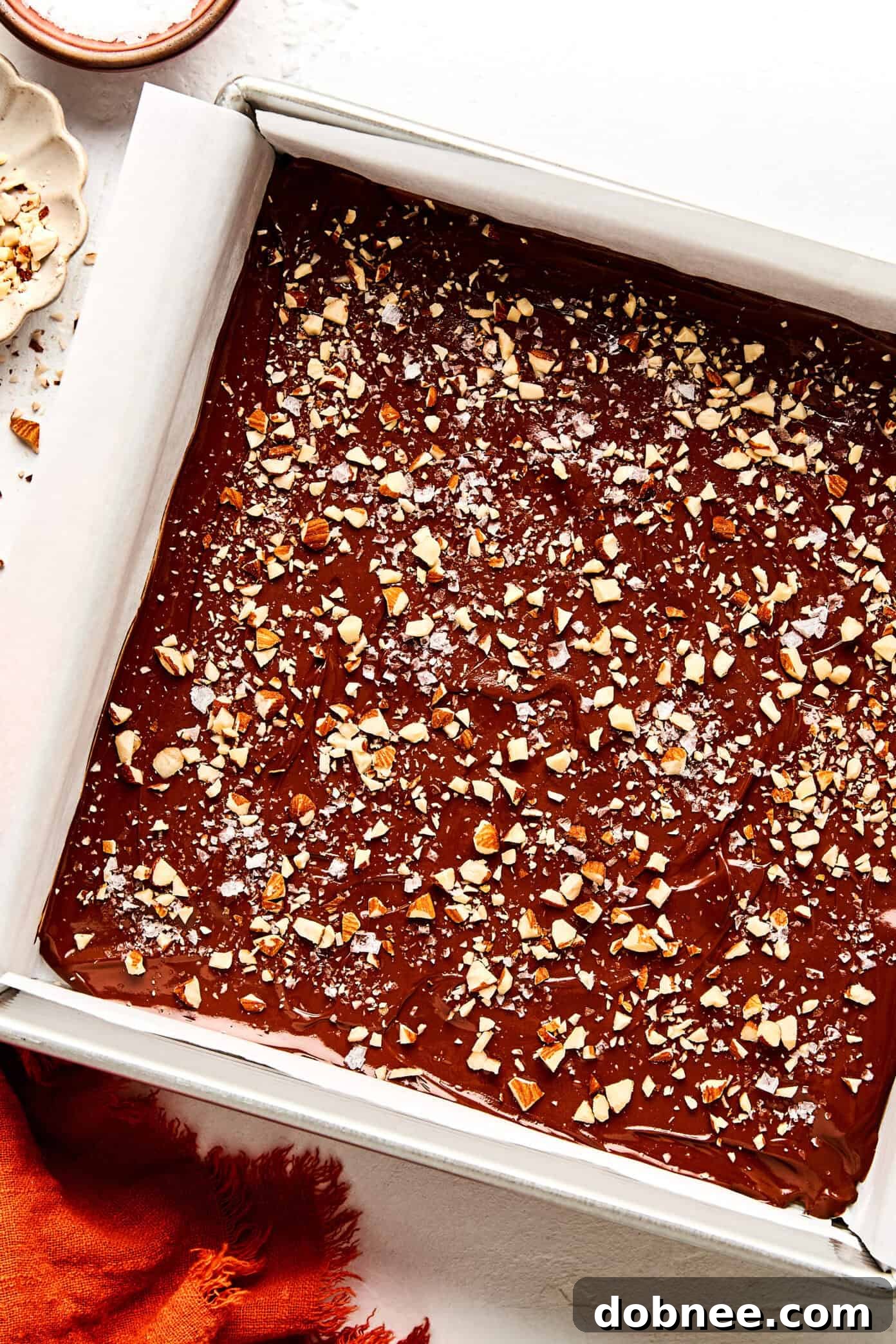 Various pieces of homemade toffee, showcasing the different toppings like nuts and sea salt.