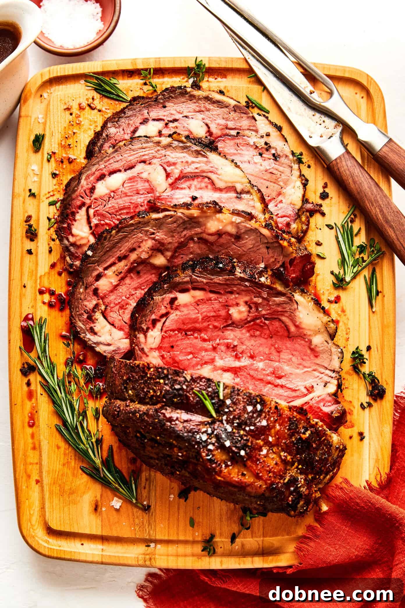 A majestic garlic herb prime rib roast, perfectly browned and seasoned, ready for the oven.