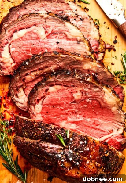 A beautifully roasted prime rib, golden brown and juicy, served with a side of au jus.