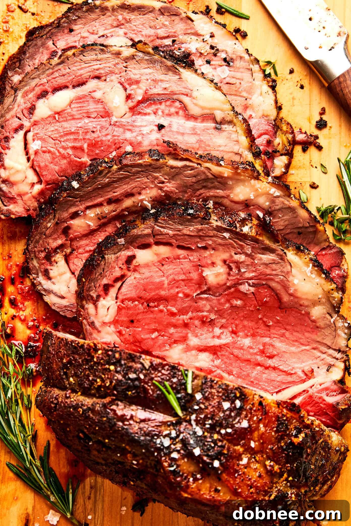 A festive holiday table setting featuring a magnificent prime rib roast as the centerpiece, surrounded by an array of delectable side dishes.