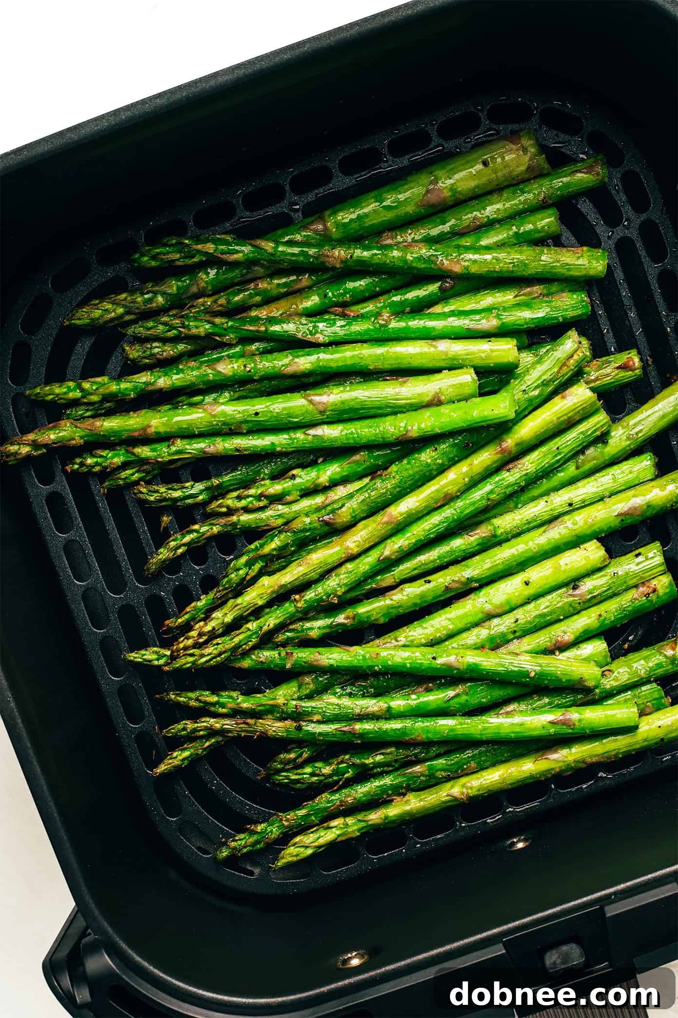 Air fried asparagus with lemon wedges and Parmesan