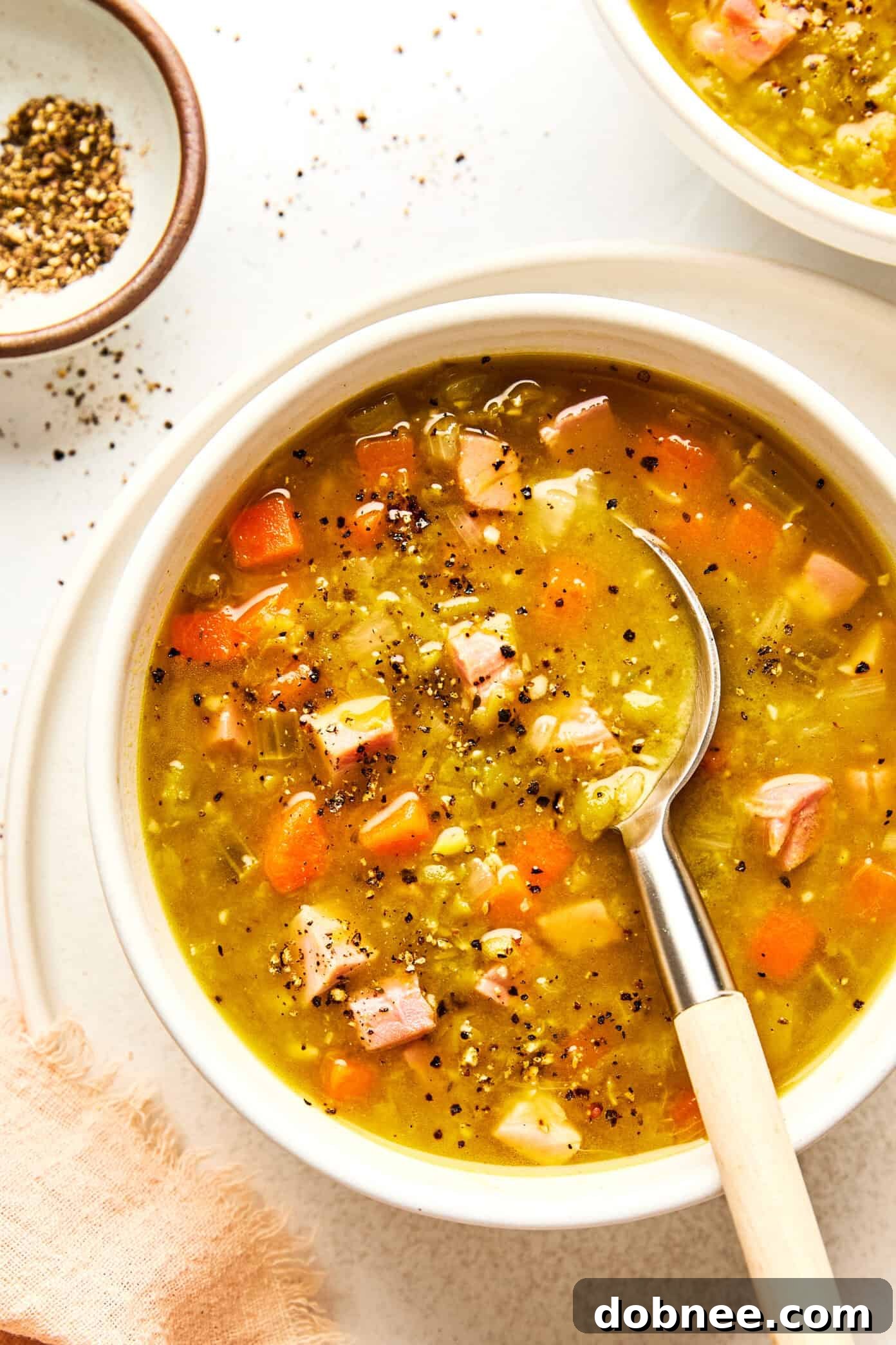 A close-up shot of the rich texture of split pea soup with ham.