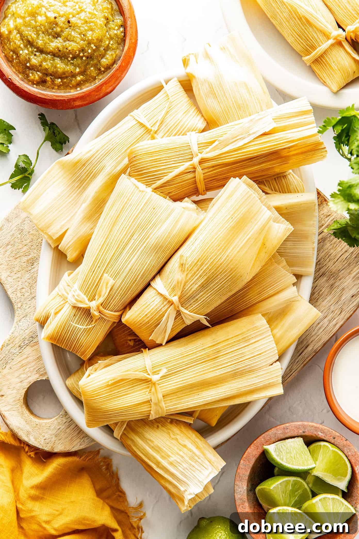 Green Chile Chicken Tamales 6 Steamed green chicken tamales piled high on a serving platter