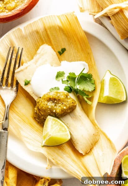 A vibrant platter of freshly steamed Green Chicken Tamales (Tamales Verdes)